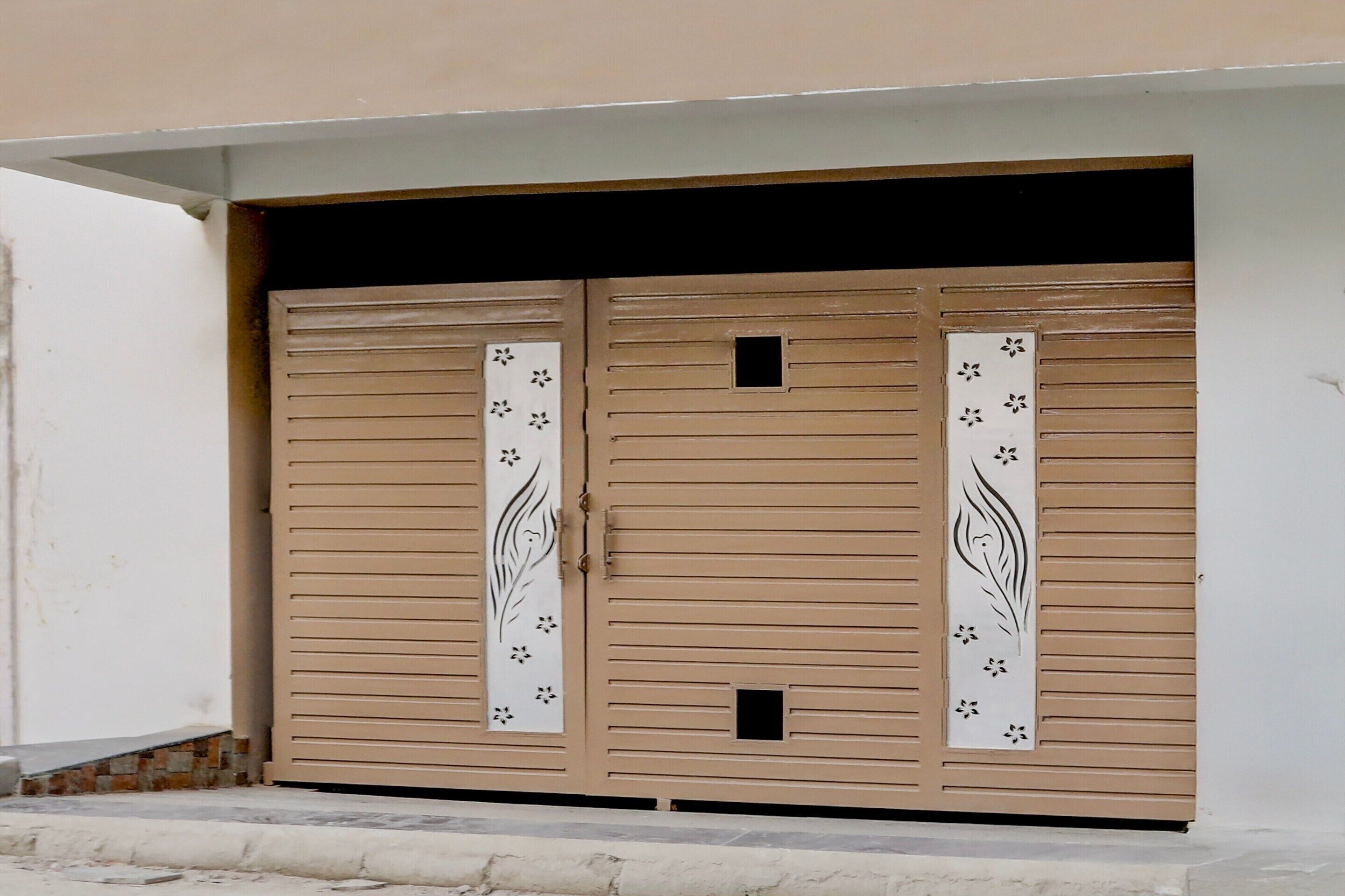 A set of double doors with decorative panels and a small square window.