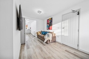 A modern interior with a sofa, a fluffy rug, and a white wardrobe. - 6|Bright Bristol Escape: Ideal for the Whole Group (Bristol)
