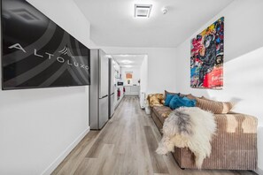 A modern interior with a sofa, a fluffy rug, and a wall-mounted artwork. - 6|Bright Bristol Escape: Ideal for the Whole Group (Bristol)