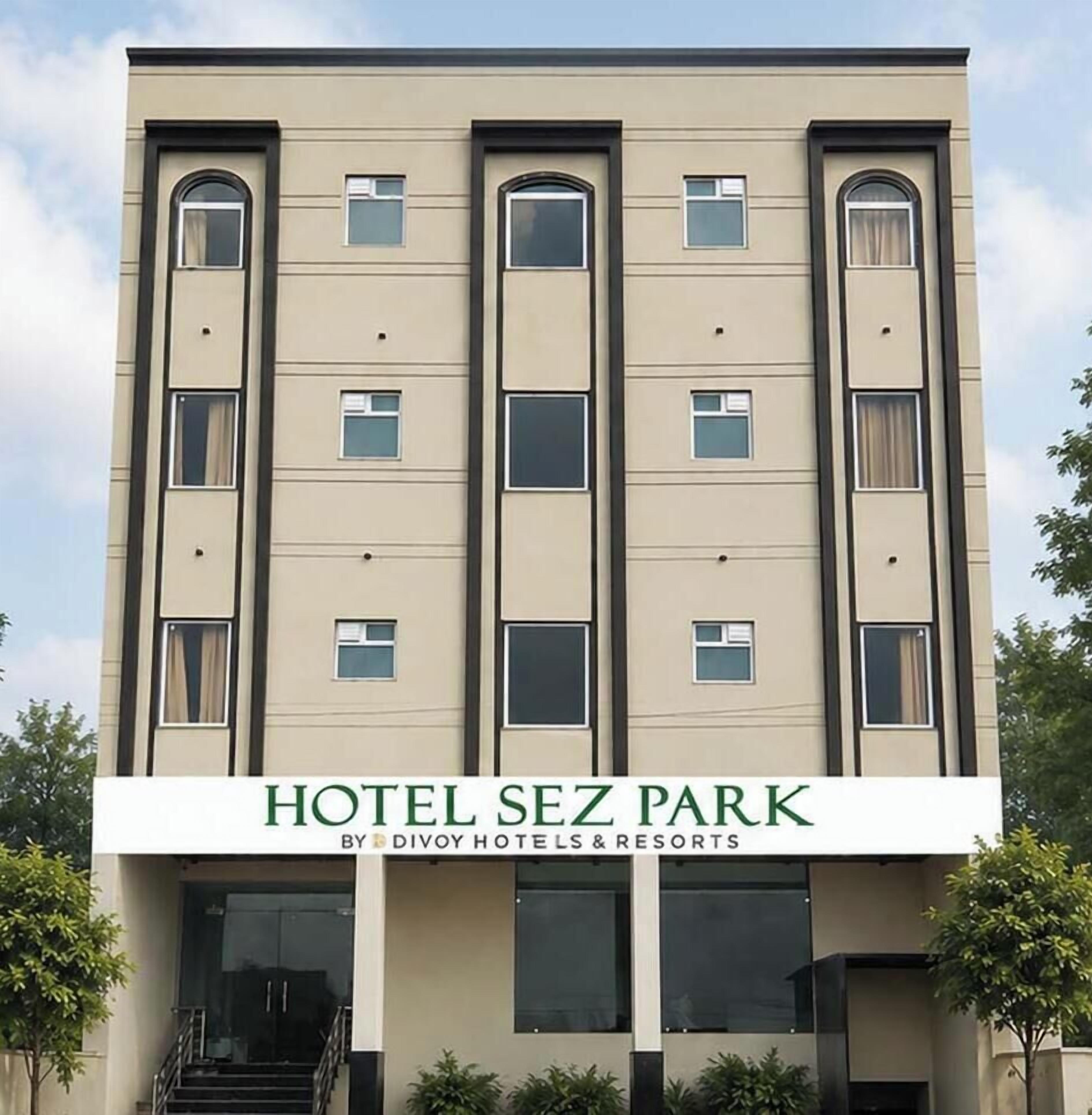 A multi-story hotel building with a sign reading 'HOTEL SEZ PARK BY DIVOY HOTELS & RESORTS'.