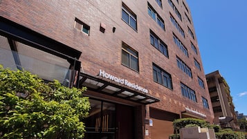 A multi-story brick building with a sign reading 'Howard Residence.'
