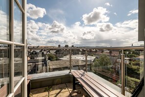 A balcony with a view of a cityscape, including buildings and a bridge. - Century Court (No 10) | St Andrews (St Andrews)