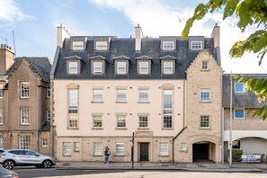 A multi-story building with a central entrance, large windows, and a flat roof. - Century Court (No 10) | St Andrews (St Andrews)