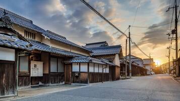 A traditional Japanese street with wooden buildings and a clear sky.