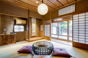 A traditional Japanese room with tatami flooring, a shoji screen, and a hanging paper lantern. - Nipponia Fukusumi Shukubamachi (Sasayama)