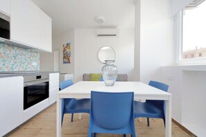 A modern kitchen with white cabinets, a built-in oven, and a colorful backsplash. - Apartment in Rome with 1 bedrooms sleeps 4 (Rome)