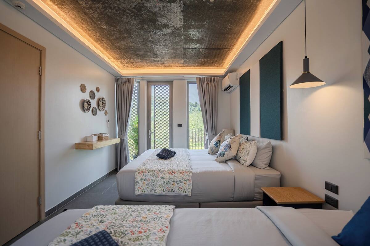 Family Premium Room Triple with Kitchenette Street View | Cofres nos quartos, escrivaninha, ferros/tábuas de passar roupa