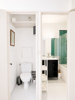 A bathroom with a toilet, a sink, and a shower area. - Le Thiers Azur AP4520 by Riviera Holiday Homes (Nice)