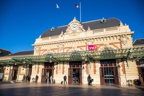 A historic building with a prominent clock tower and a sign reading 'SNCF' indicating it is a train station. - Le Thiers Azur AP4520 by Riviera Holiday Homes (Nice)