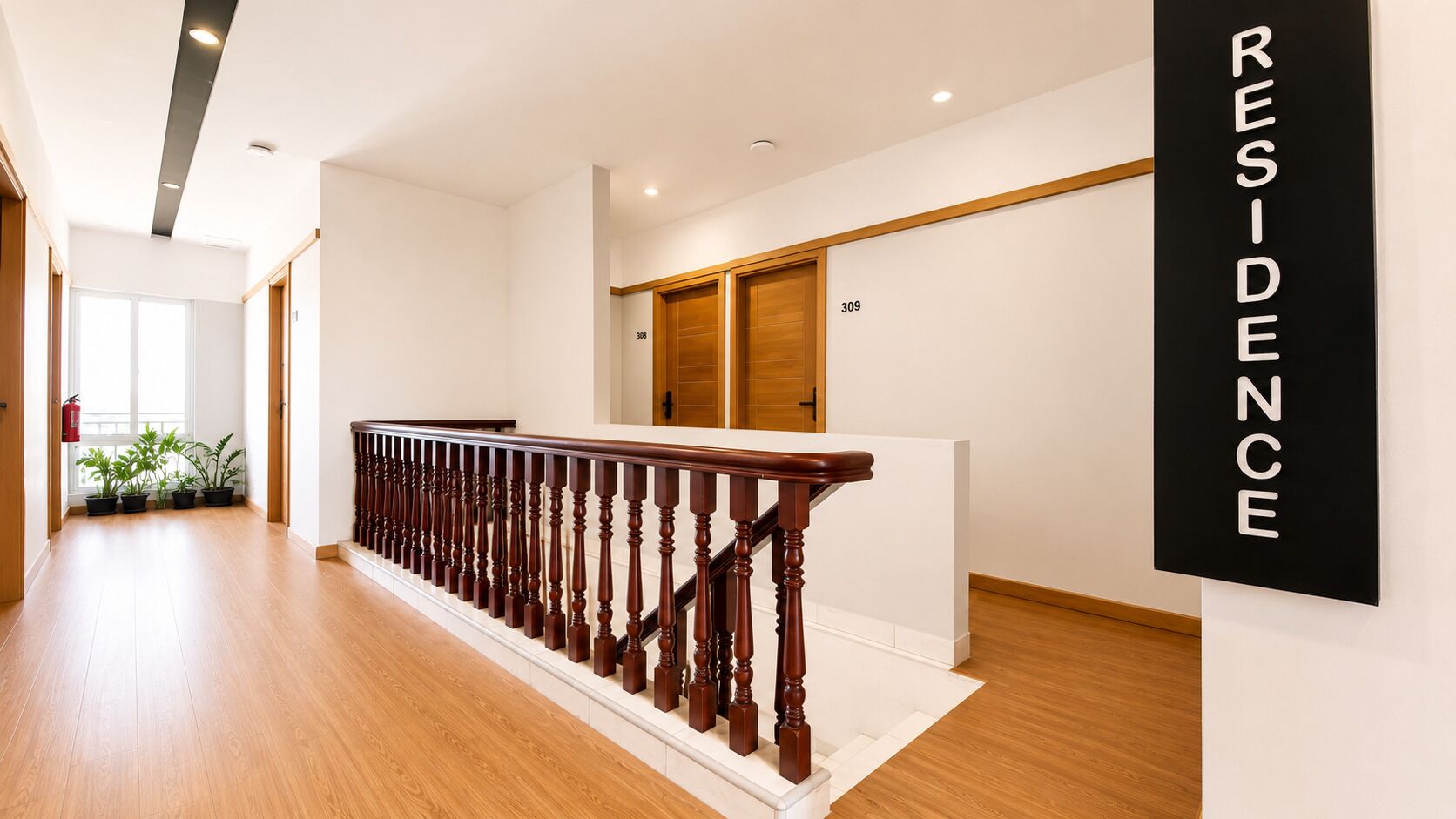 A modern residential interior with a wooden staircase, a white wall with a 'RESIDENCE' sign, and a door marked with the number 309.
