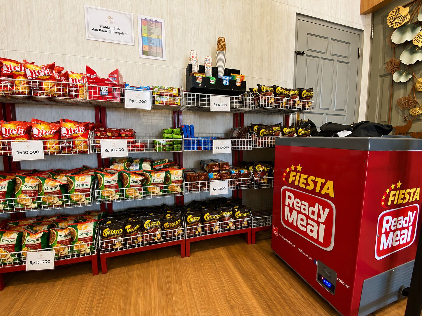 Un corridoio con snack confezionati assortiti e una macchina distributrice per pasti 'Fiesta Ready Meal'.