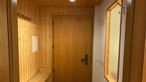 A wooden door with a small window, a bench, and a door handle. - Chalet Gerbera Appartement/Fewo, Bad, WC 5-Bettwohnung by Interhome (Rosswald)