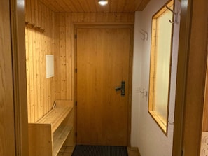 A wooden door with a small window, a bench, and a door handle. - Chalet Gerbera Appartement/Fewo, Bad, WC 5-Bettwohnung by Interhome (Rosswald)