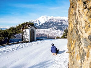 A snow-covered landscape with a small building and a person in a blue jacket. - Chalet Valeria 4-Bettwohnung, Parterre, 2 Schlafräume Valeria EG by Interhome (Rosswald)