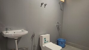 A bathroom with a sink, toilet, and shower.