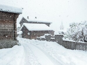 A snow-covered wooden building with a visible chimney and a snow-covered fence. - Appartement Binna 4-Bettwohnung, Dusche, WC 3-Bettwohnung, Dusche, WC by Interhome (Rosswald)