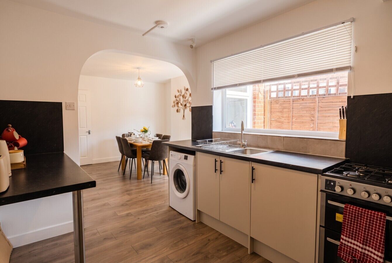 Bright open kitchen with gas range and washer for effortless self-catering.