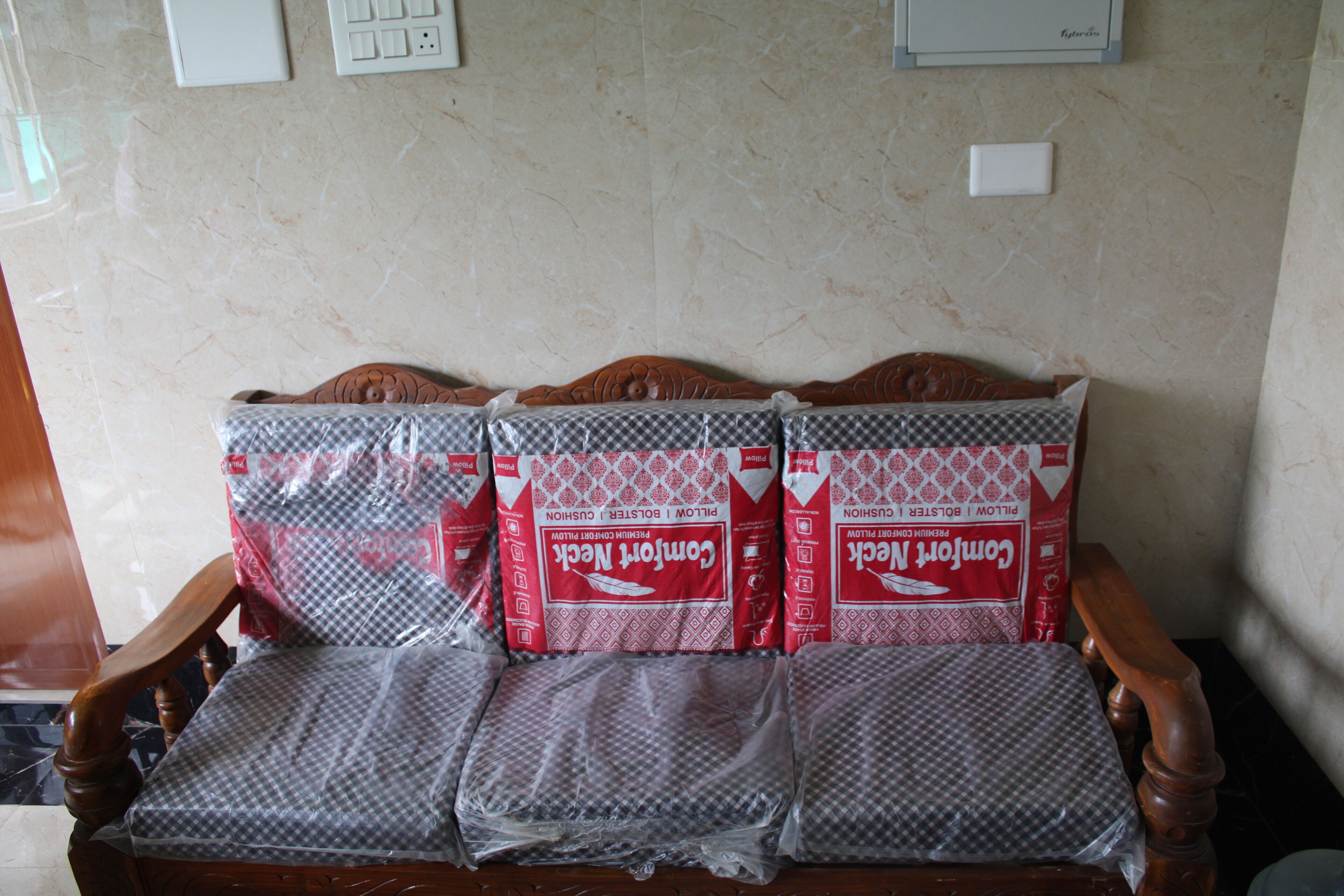 A wooden chair with a cushion covered in a checkered fabric.