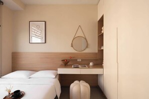 A hotel room with a bed, a bedside table with a cup and book, a wall-mounted mirror, and a framed artwork. - Stunning 3BR+2BA Apt w/View | Near Bui Vien & D1 (Thành phố Hồ Chí Minh)
