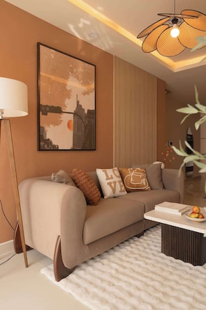 A modern living room with a sofa, a coffee table, and a unique ceiling light fixture. - 4BR · 5 Beds · 2BA · Fireworks/Bitexco View · D4 (Thành phố Hồ Chí Minh)