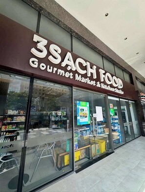 Een winkelgevel met een bord waarop '3SACH FOOD Gourmet Market & Kitchen Studio' staat.