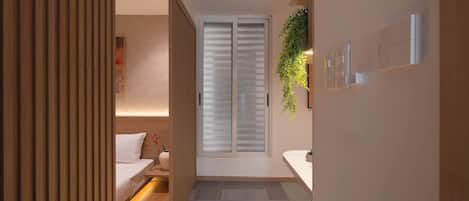 Un baño moderno con ducha, lavamanos e inodoro.