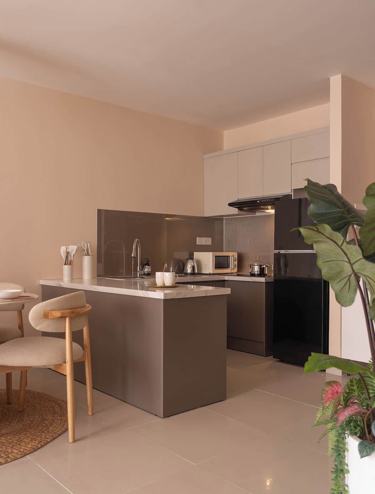 A modern kitchen with a central island, stainless steel appliances, and a minimalist design.