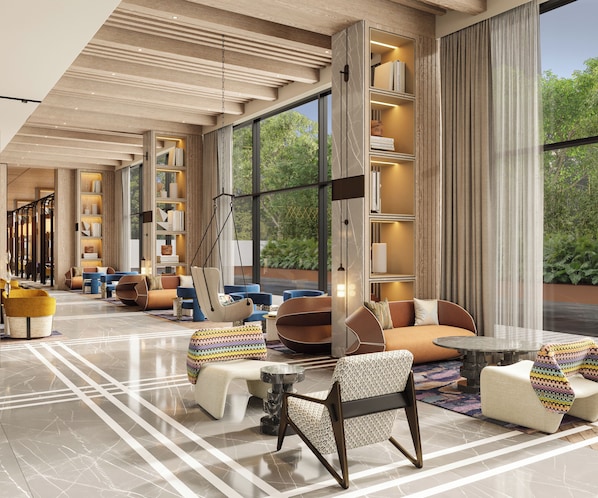 A spacious lounge area with modern furniture, large windows, and a view of greenery outside.
