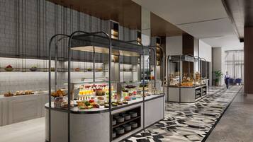Un área de desayuno de hotel moderna con estaciones de autoservicio, pisos de mármol y un diseño contemporáneo y limpio.