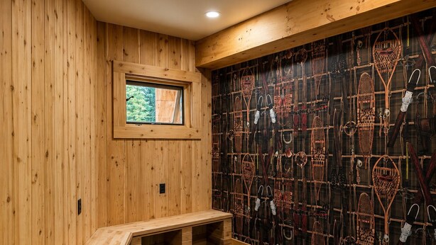 A wooden room with a bench, a window, and a wall with various items. - Luxury Stowe Retreat Sleeps 18 Hot Tub & Mtn Views (Stowe)