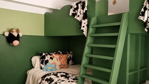 A bunk bed room with a ladder, a stuffed cow toy, and a pillow with a cow pattern. - Luxury Stowe Retreat Sleeps 18 Hot Tub & Mtn Views (Stowe)