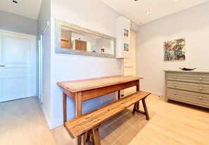 A room with a wooden bench, a white cabinet, a mirror, and a wall with a painting. - New! N&J - BUFFA HARMONY - Central - Close sea (Nice)