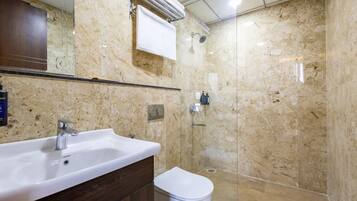 A bathroom with a marble sink, a mirror, a towel rack, and a shower.