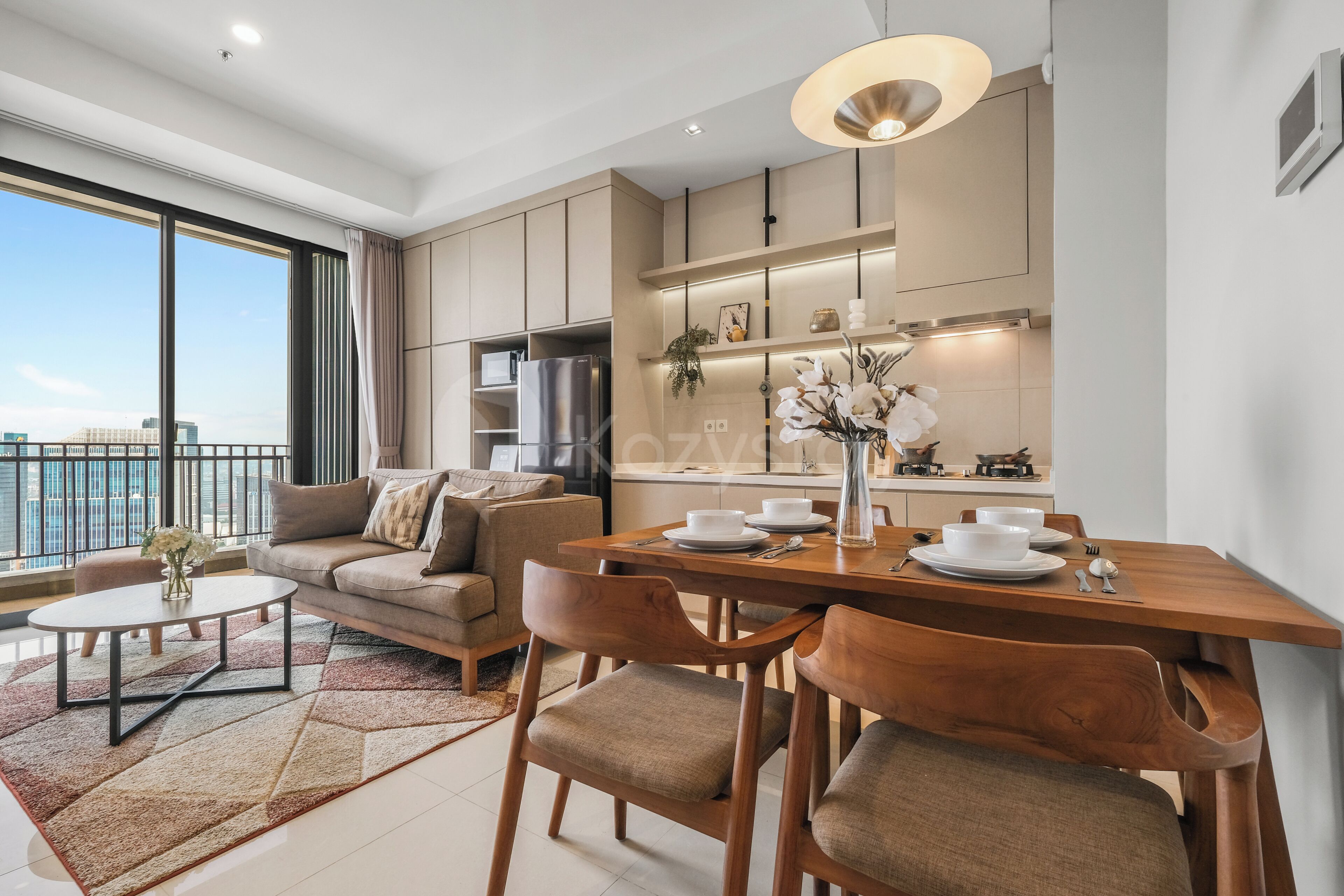 A modern apartment with a dining area, kitchen, and a balcony with a city view.