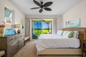 A bedroom with a bed, a dresser, a lamp, and a ceiling fan. - Pili Mai 6F by Alekona Kauai - 2BR Condo access to fitness (Koloa)