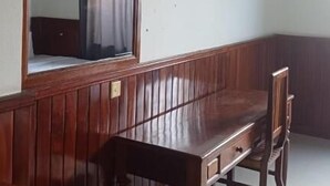 A room with a wooden bench, a television mounted on the wall, and a mirror with curtains. - Mongkol Angkor Residence & Spa (Siem Reap)