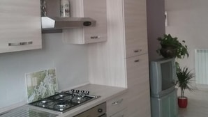 A modern kitchen with a gas stove, oven, and cabinets.