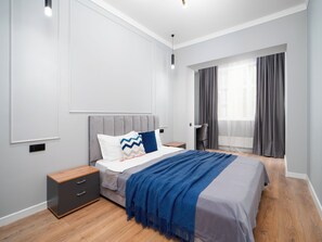 A modern bedroom with a bed, bedside tables, a desk, and a window with curtains. - Comfort City Residence with beatiful vew (Almaty)