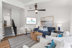 A modern living room with a sofa, coffee table, and a framed picture on the wall. - 3BR Beachside Villa with Community Pool, Short Walk to the Beach (Hilton Head Island)