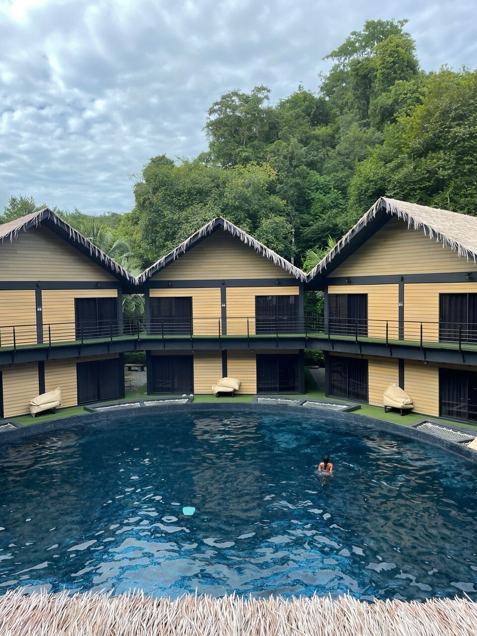 A pool area with a clear view of the sky and surrounding greenery.