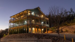 A multi-story building with balconies and a stone retaining wall. - All Decked Out in Pigeon Forge (Pigeon Forge)