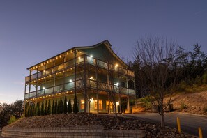 A multi-story building with balconies and a stone retaining wall. - All Decked Out in Pigeon Forge (Pigeon Forge)