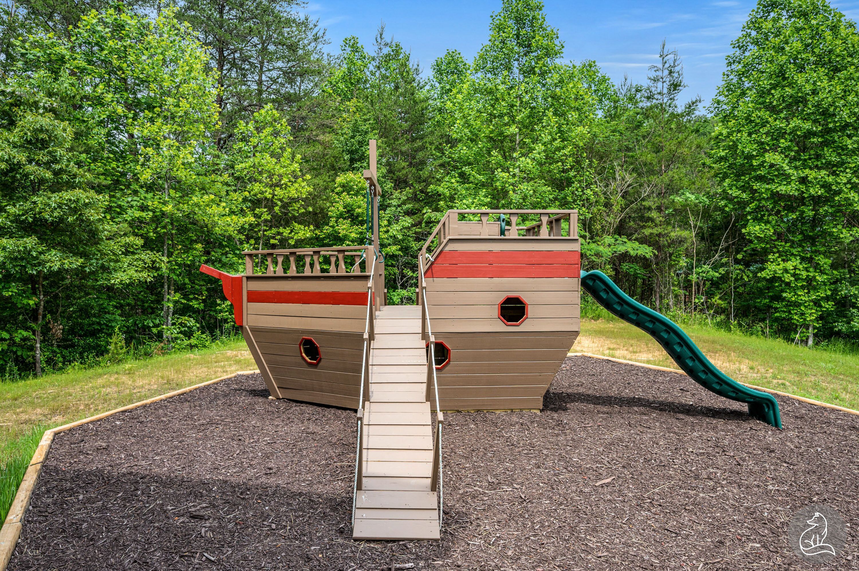 A playground with a slide and climbing structures.