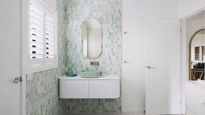 A bathroom with a white vanity, a green sink, and a large mirror. - Sandy Toes Haven a Lux Pet-Friendly Retreat (Nelson Bay)
