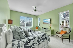 A bedroom with a bed, a desk, a chair, and a ceiling fan. - Grande Geneva at The Dunes (Naples)
