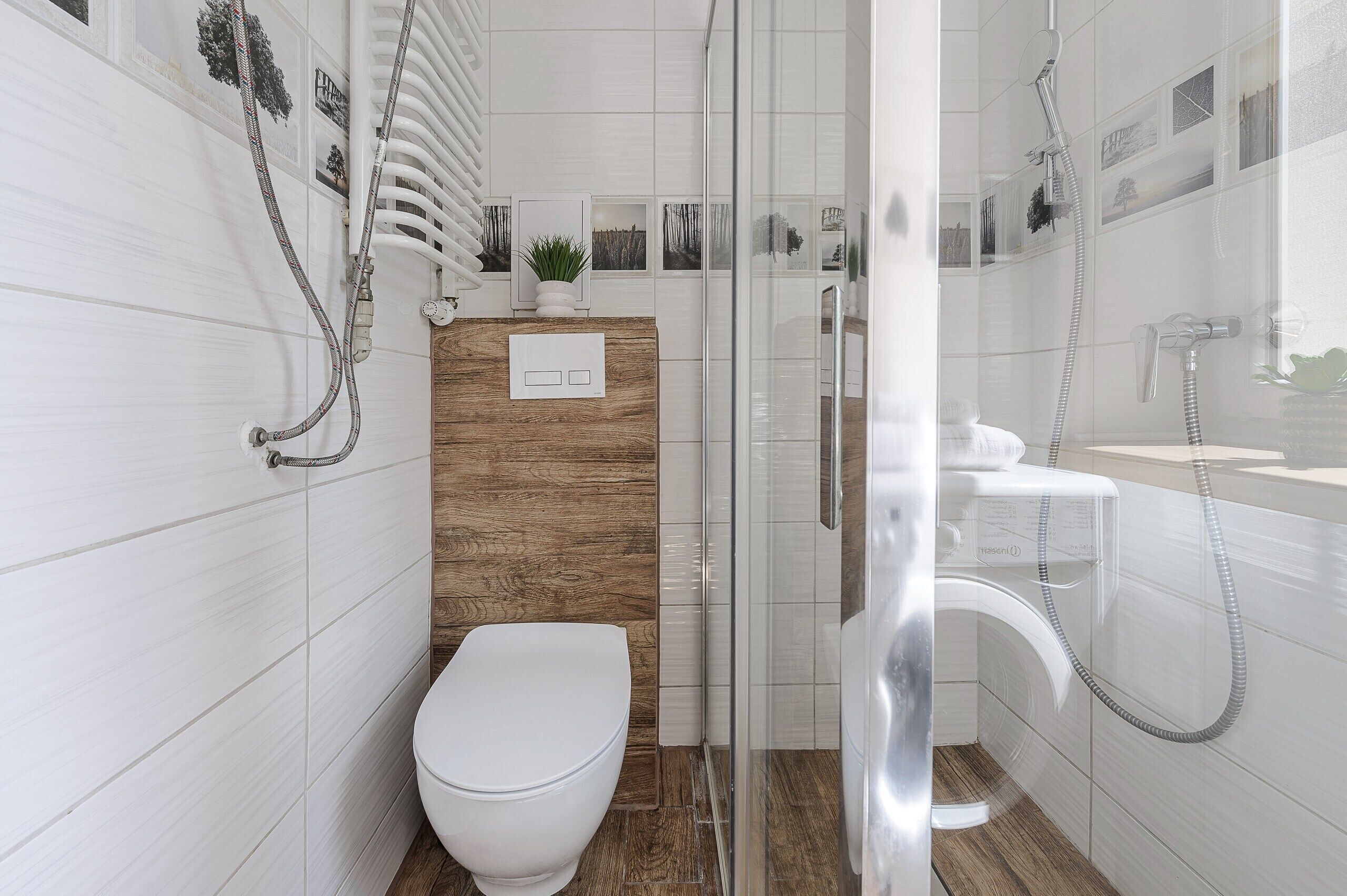 A modern bathroom with a toilet, a shower, and a sink.
