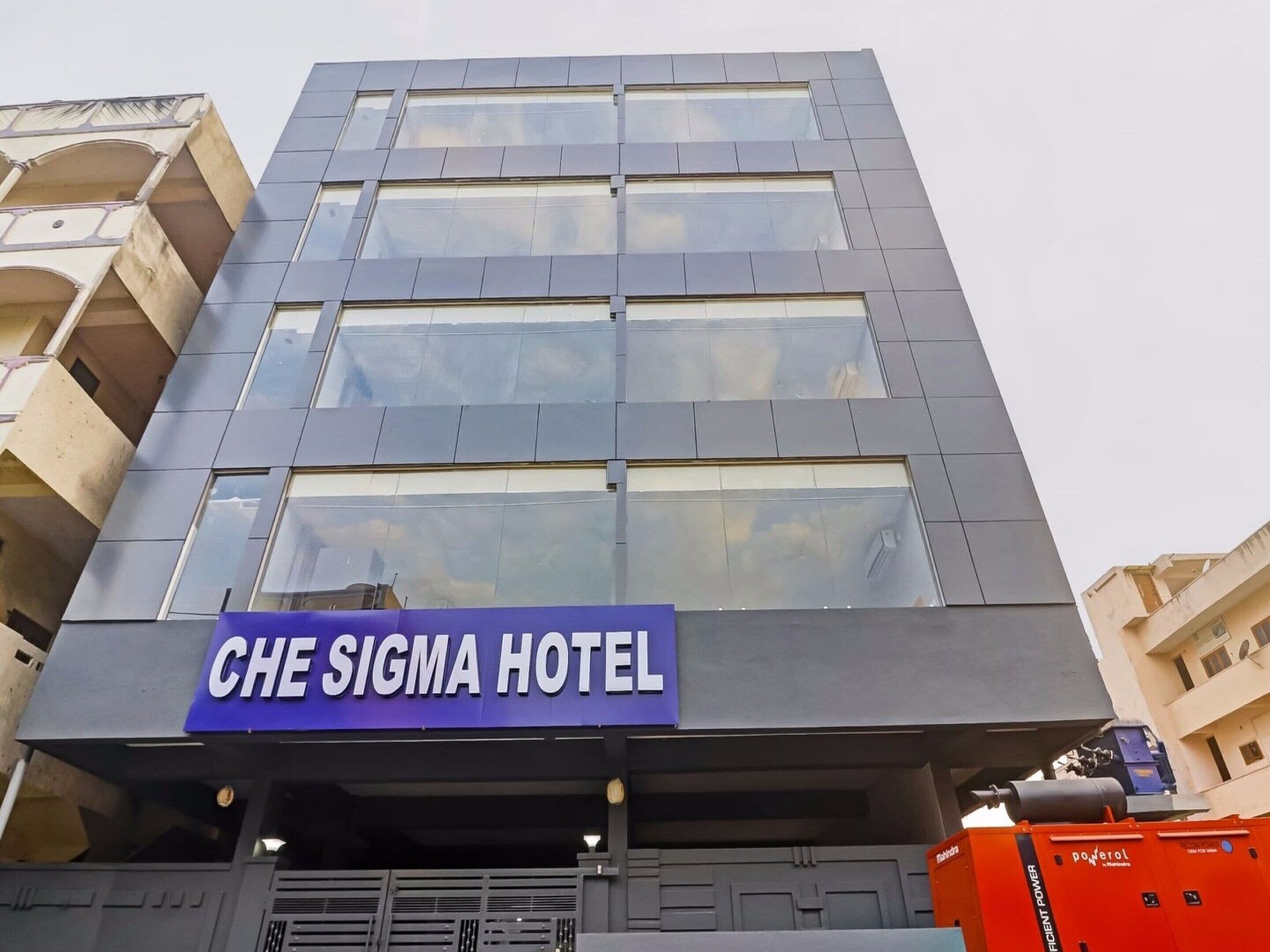 A modern hotel building with a prominent sign for 'CHE SIGMA HOTEL' on the facade.