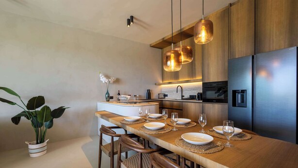 A modern kitchen with a central island, stainless steel appliances, and pendant lighting. - Private Pool Escape - Luminara at The Reef (Sint Michiel)