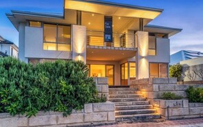 A modern two-story house with a balcony, a front entrance with steps, and a 'For Sale' sign. - Luxury 5BR canal retreat with private jetty, alfresco, water views & space for 10. (Dudley Park)