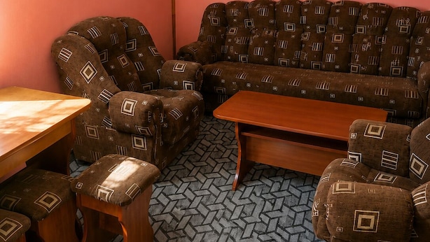 A room with a sofa set, a wooden table, and a patterned carpet. - Lake Sevan Private Cottage with Yard (Shoghakat)